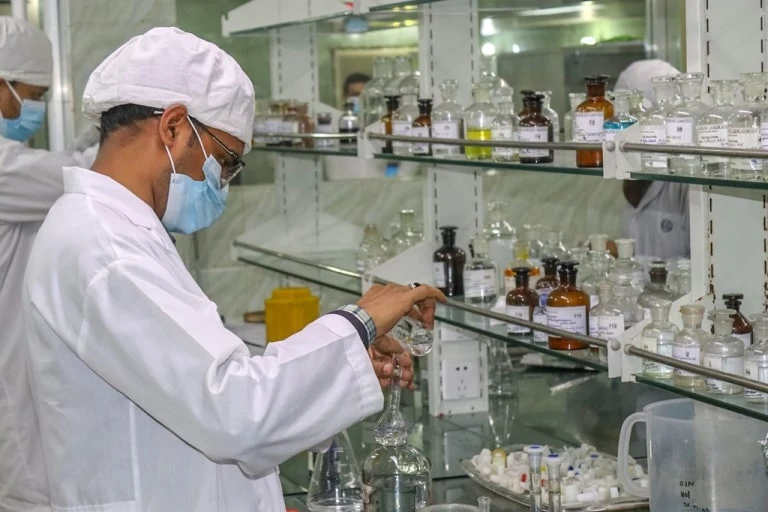An Albion laboratory professional preparing a sample
